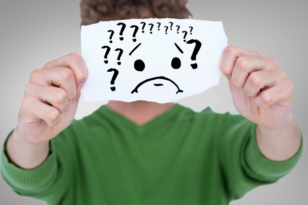 man-with-a-piece-of-paper-with-question-marks_1134-556